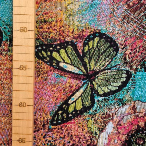 Tejido Jacquard AQUAMARINA con mariposas multicolor y fondo azul. Ancho 140